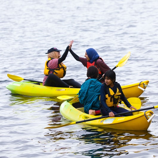 Four rangatahi in kayaks image
